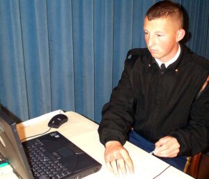 Soldier inserting CAC card into reader device