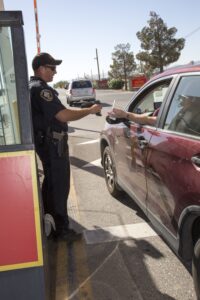 Police officer scanning Common Access Card at gate
