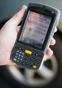 Security Forces Airman scanning CAC with DBIDS device