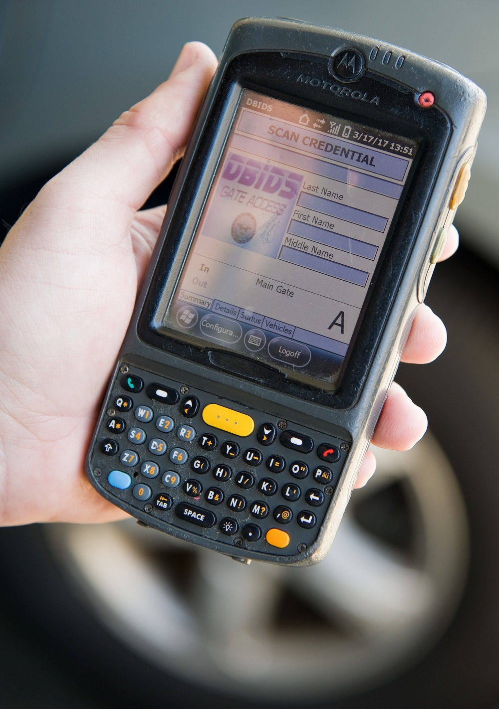 Security Forces Airman scanning CAC with DBIDS device